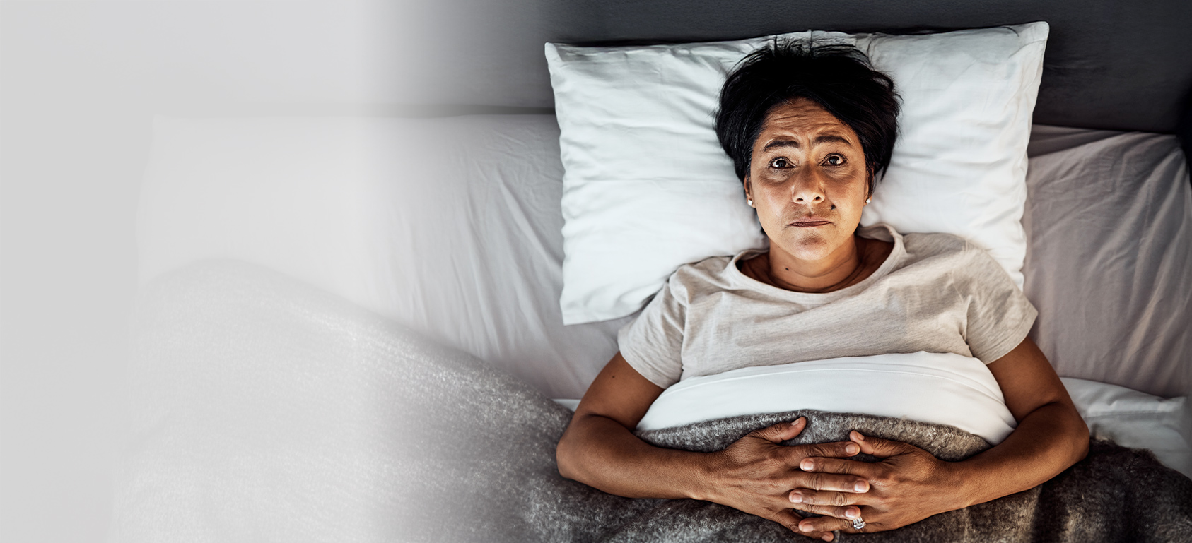 worried woman in bed